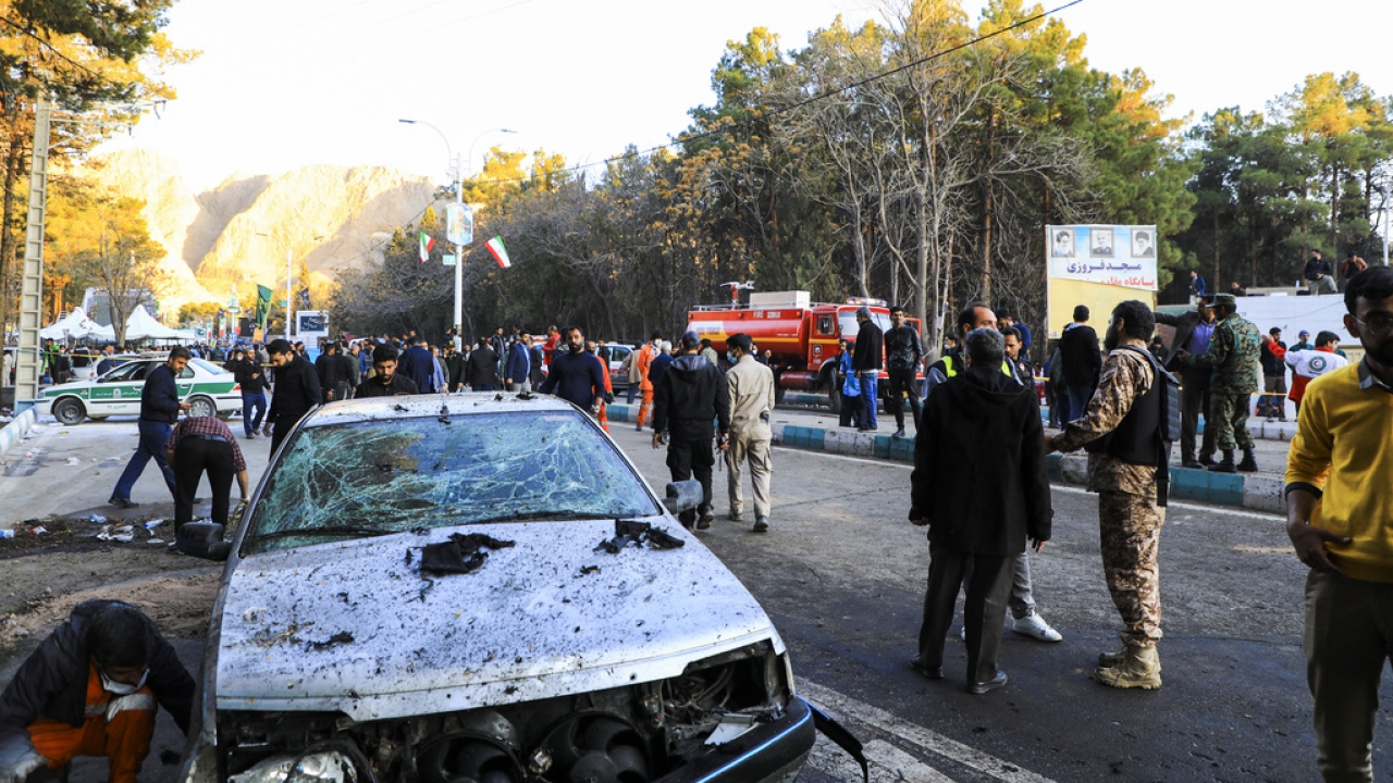 People gather at the site of an explosion in the city of Kerman.
