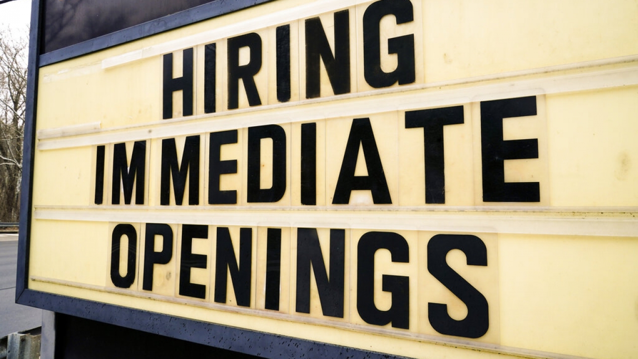 A hiring sign is posted outside business in Huntingdon Valley, Pa.