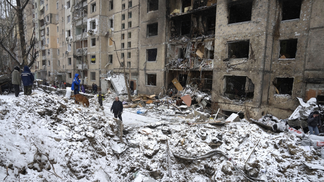 A crater of an explosion is seen next to an apartment building destroyed after a Russian attack in Kyiv, Ukraine.