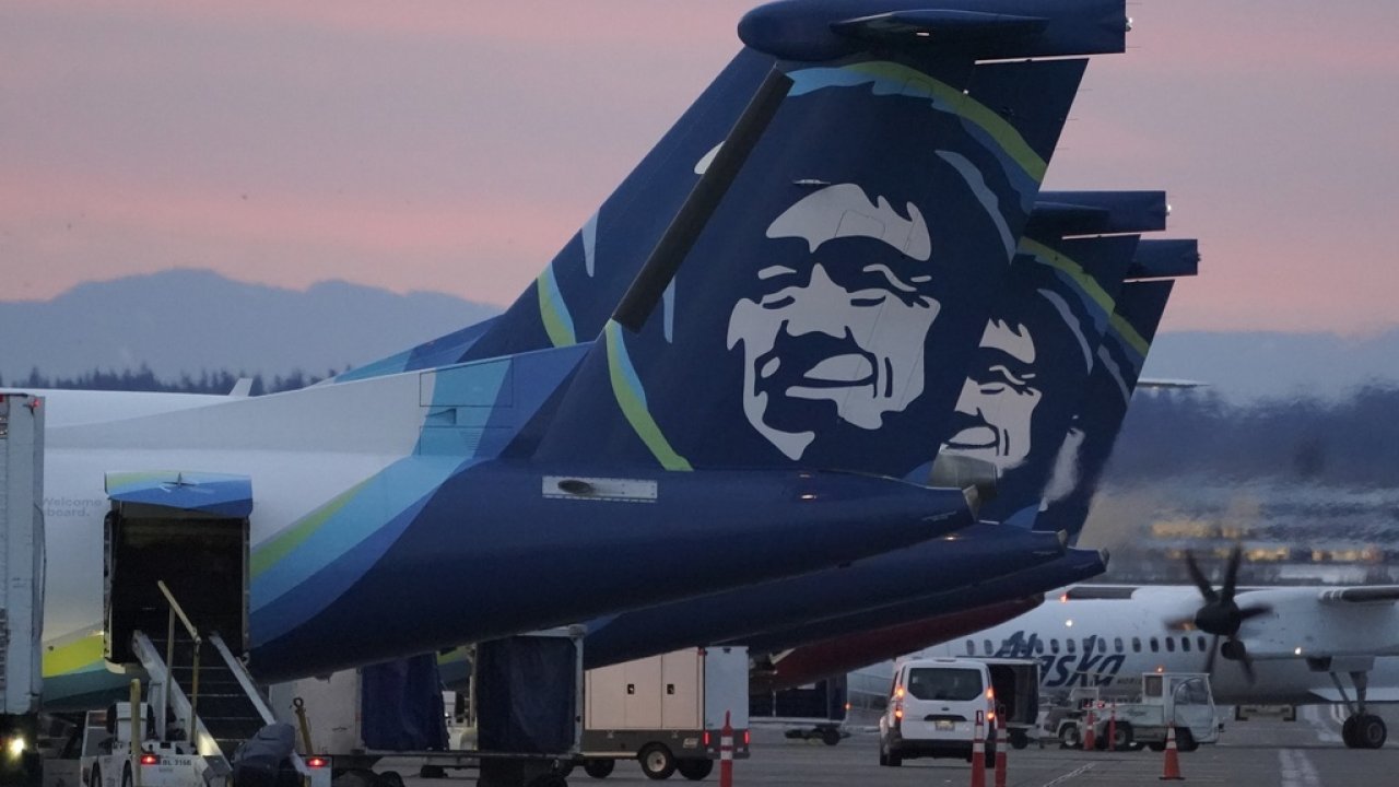 Alaska Airlines planes are shown parked at gates at sunrise, March 1, 2021, at Seattle-Tacoma International Airport.