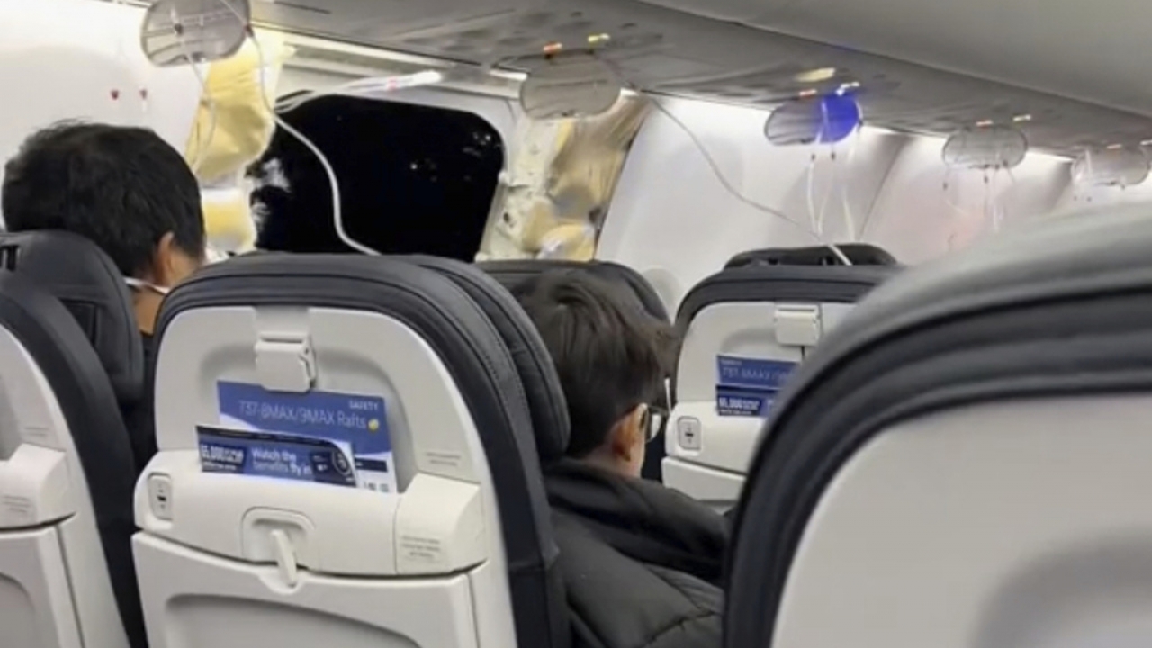 Passengers sit on board flight after a door plug broke free.