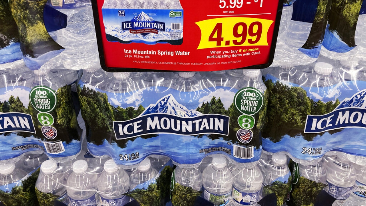 Bottled water is displayed at a grocery store.