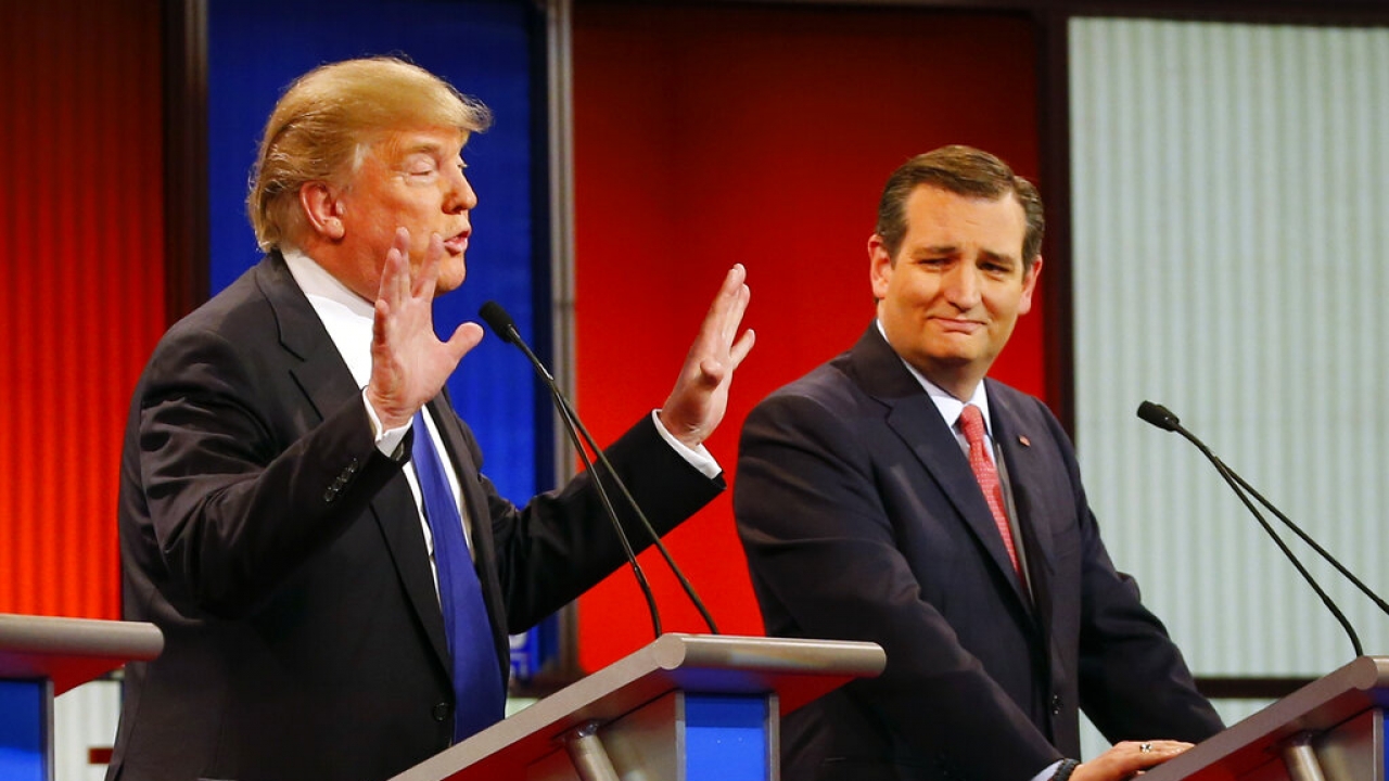 During a 2016 GOP debate, presidential candidate Ted Cruz, right, reacts as Donald Trump speaks.