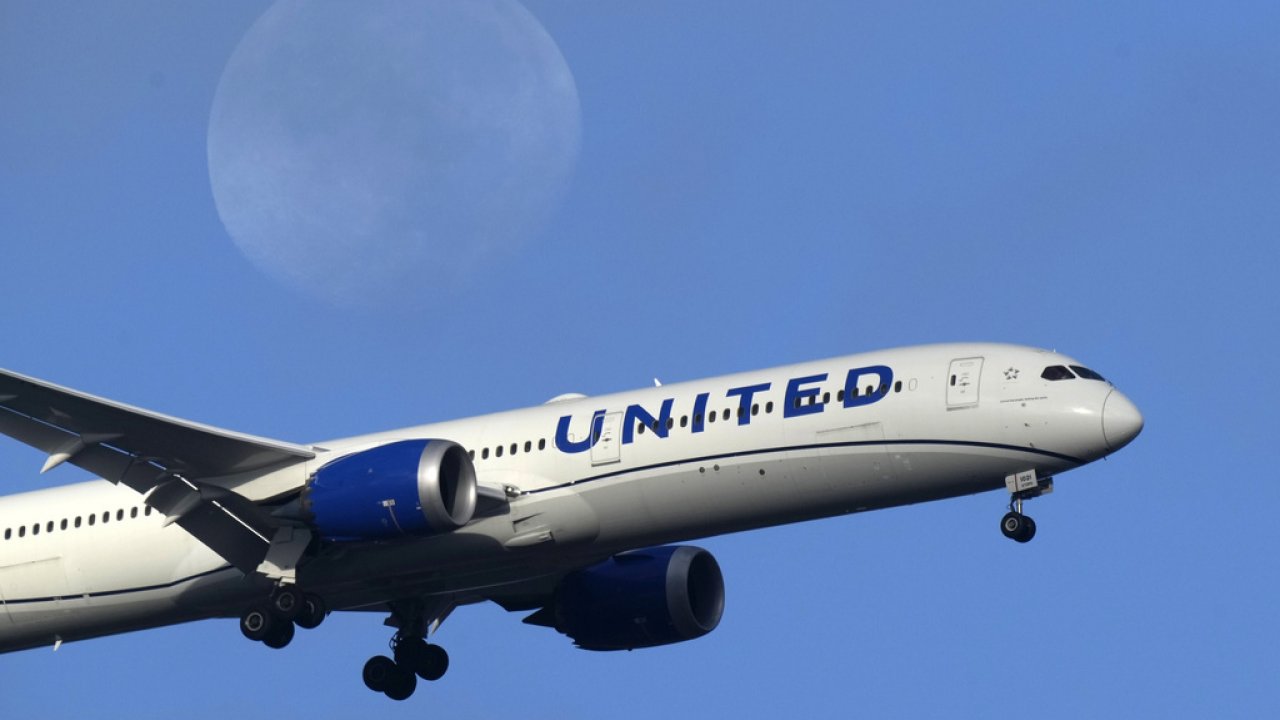 A United Airlines plane approaches for landing.