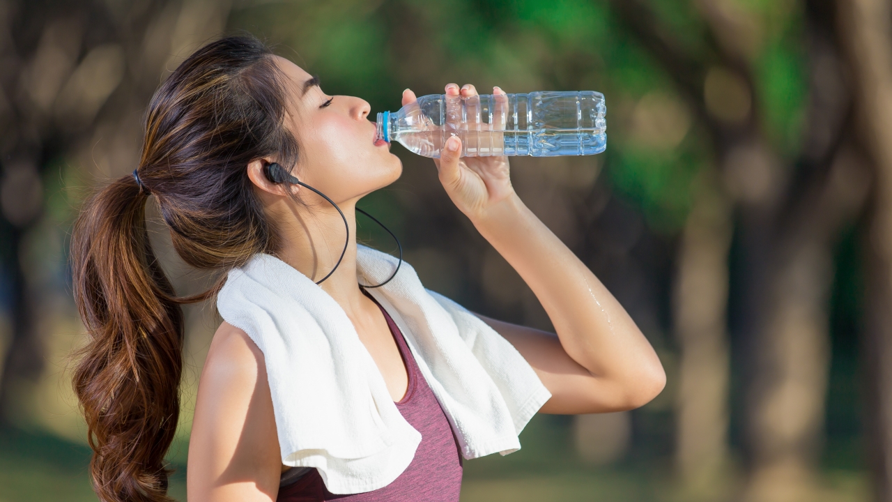 Woman drinking bottled water.