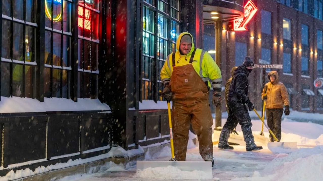 Workers clear snow in Iowa on Friday, Jan. 12