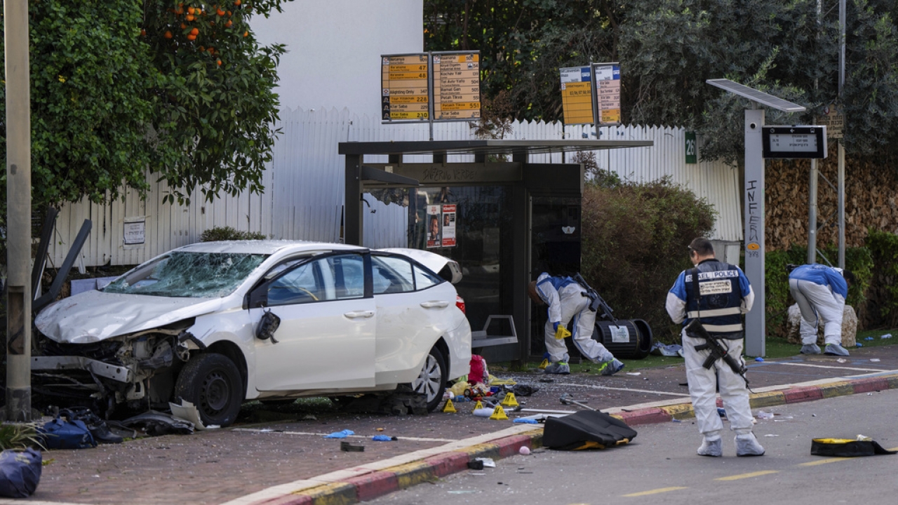 Israeli security forces work at the site of a Palestinian car-ramming and stabbing attack.