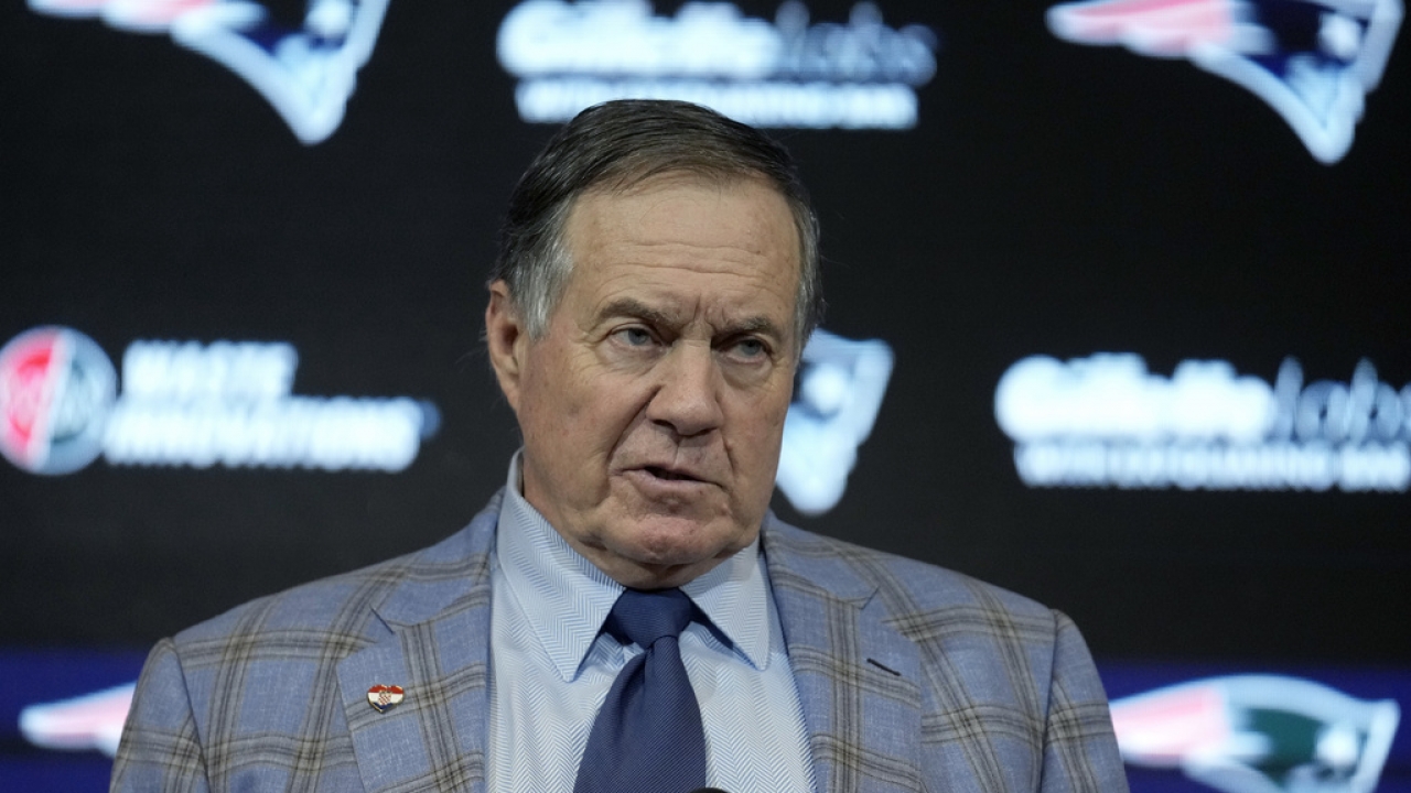 Former New England Patriots head coach Bill Belichick faces reporters .