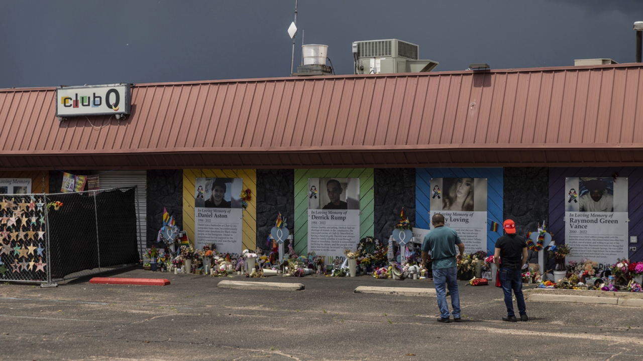 People visit a memorial outside Club Q, the LGBTQ nightclub that was the site of a deadly 2022 shooting in Colorado Springs.