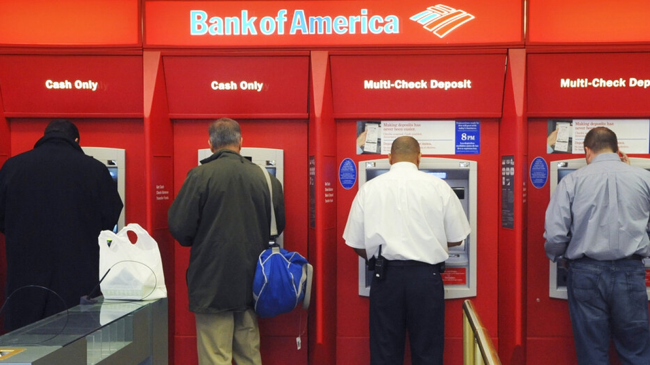 Customers use ATMs at a Bank of America branch office.