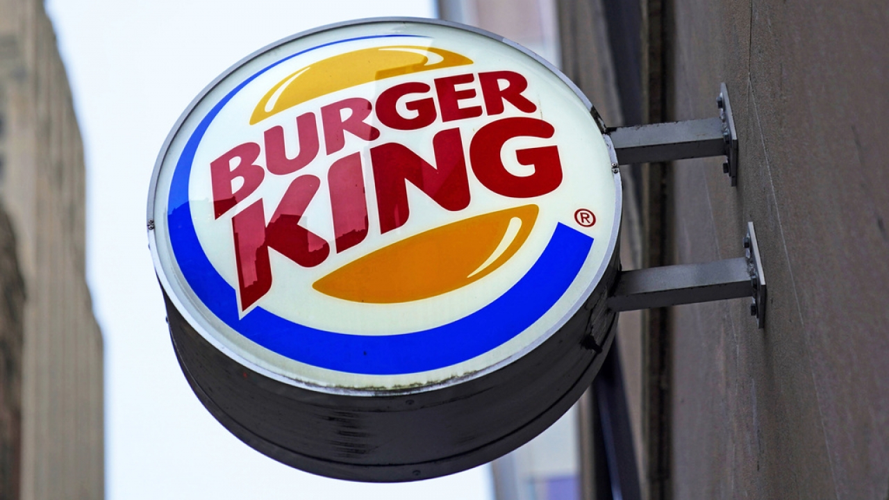 The Burger King logo is displayed on a sign outside a restaurant in downtown Pittsburgh.