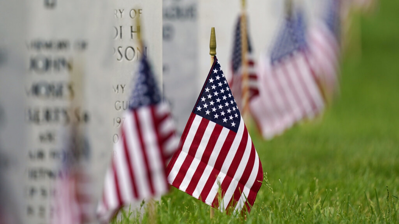 American flags beside headstones