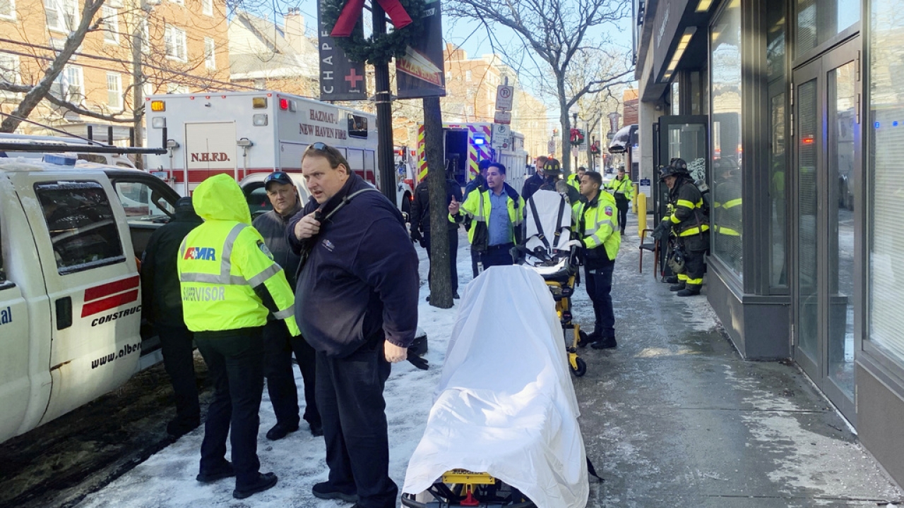 Ambulance and New Haven Fire Department personnel respond to a Yale University-owned building