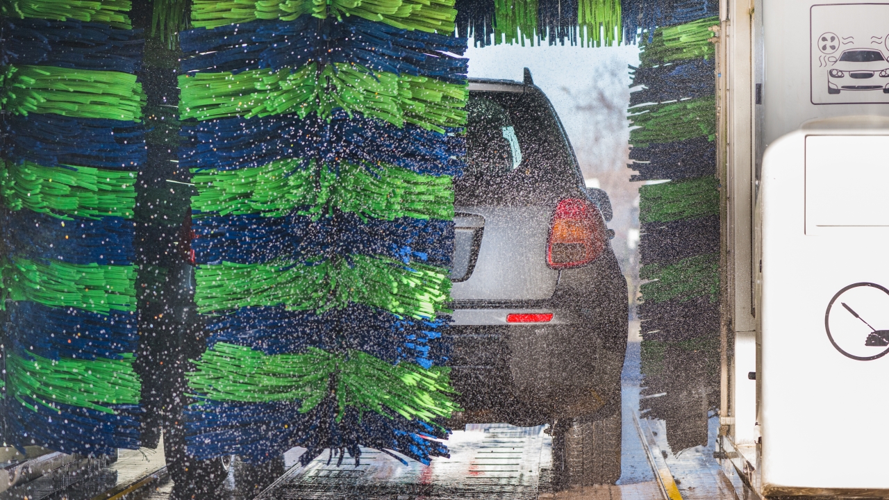 A car is shown inside of a car wash.