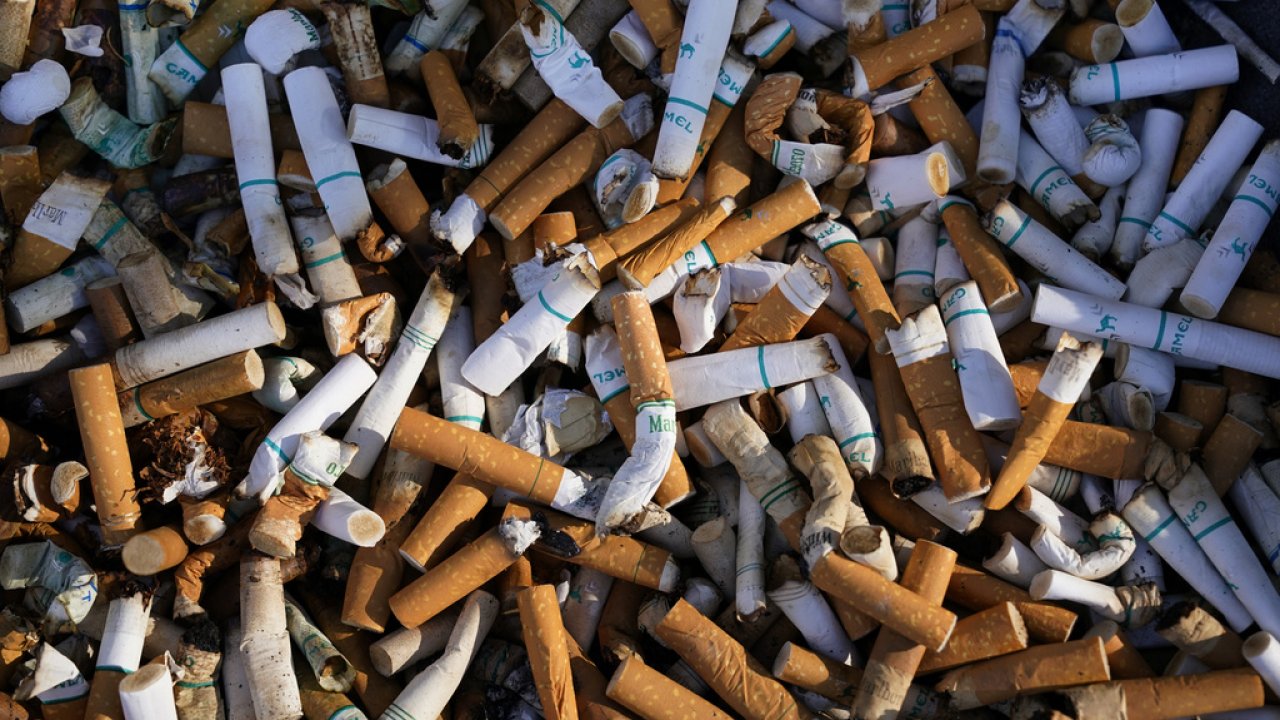 Cigarette butts fill a smoking receptacle outside a federal building in Washington.