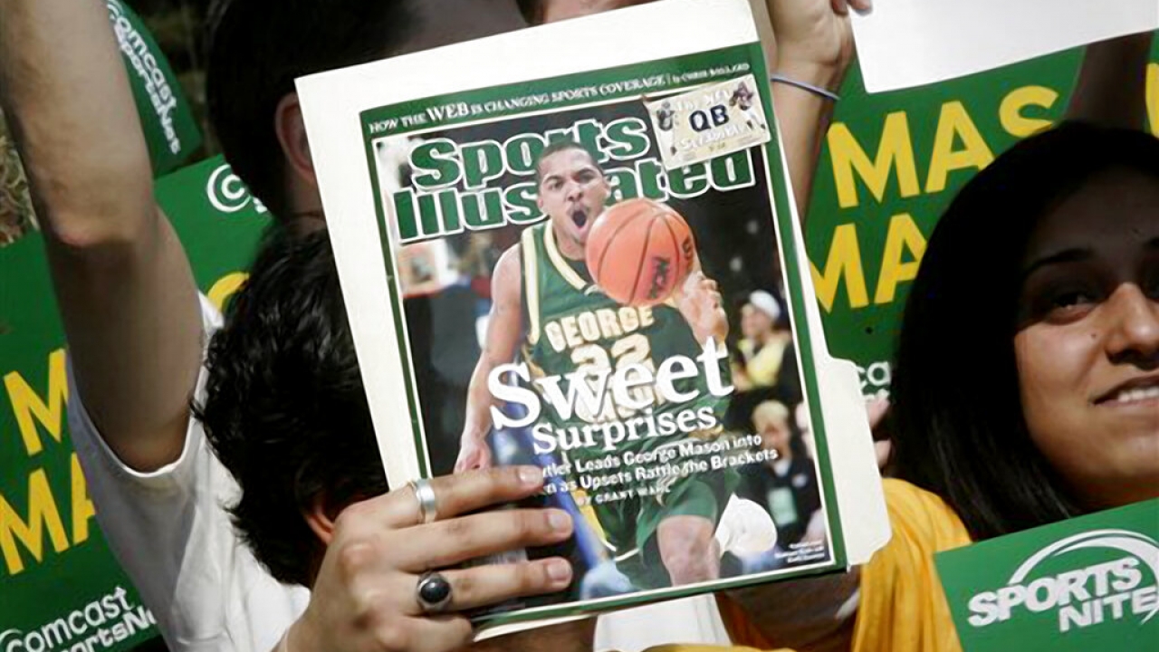 File photo of a George Mason University fan holding up the cover of Sports Illustrated.