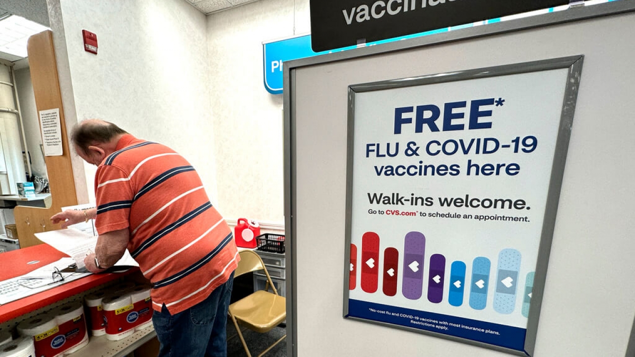 A sign for COVID and flu vaccines in a store in Illinois