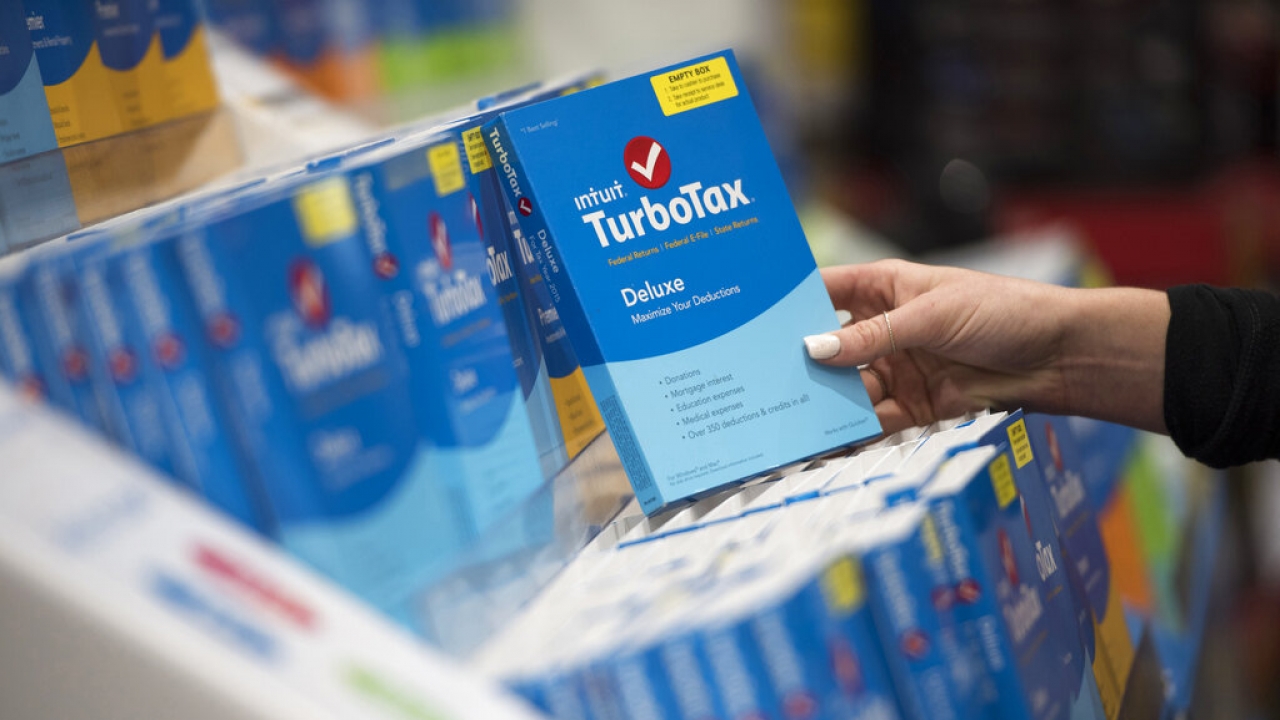 A person looks at Intuit TurboTax software on display.