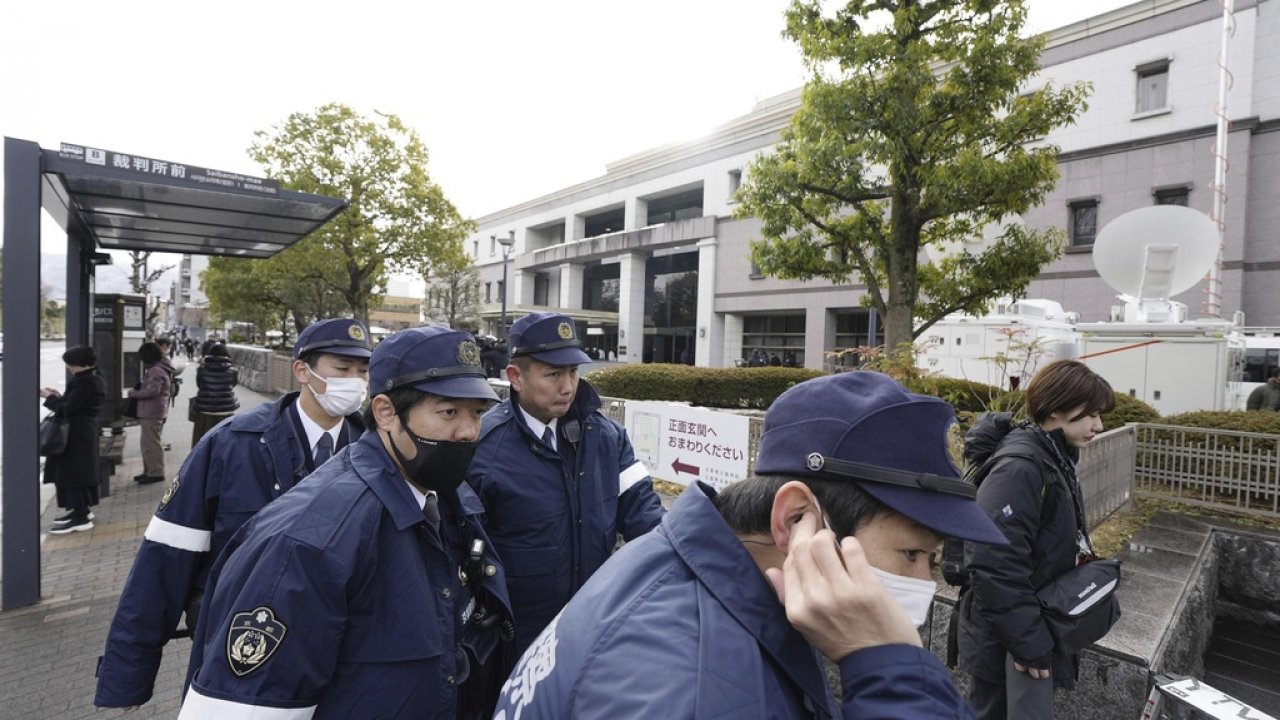 Police officers gather outside the Kyoto District Court in Kyoto.