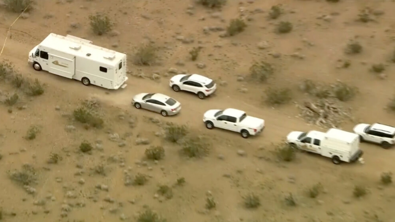 A still provided by KTLA shows law enforcement vehicles where several people were found shot to death in El Mirage, Calif.
