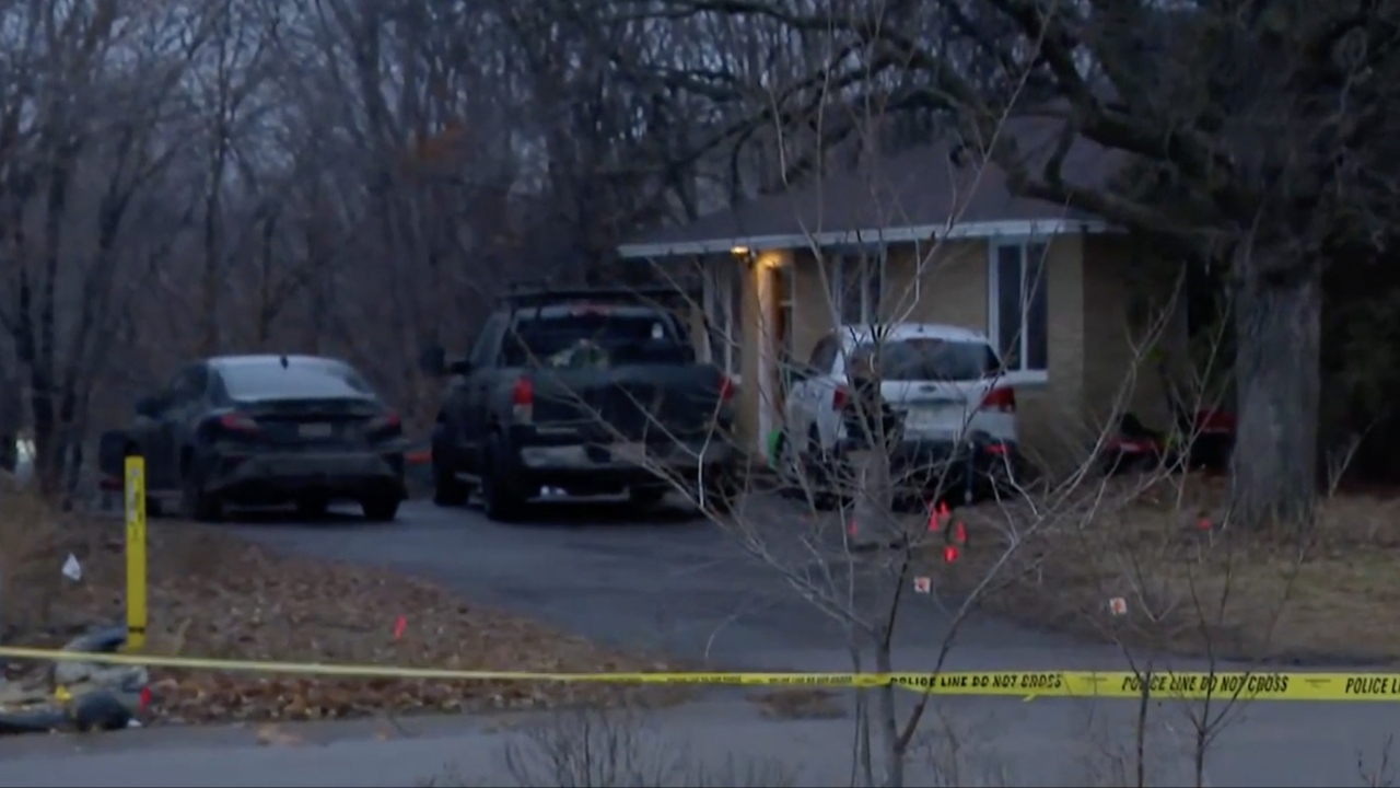 Police tape in front of a Minnesota home where three murders occurred