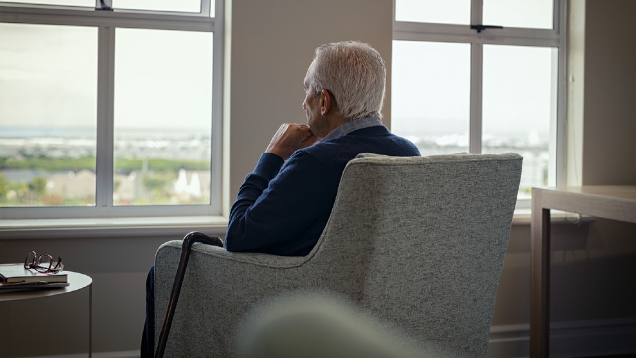 An elderly man sitting alone.