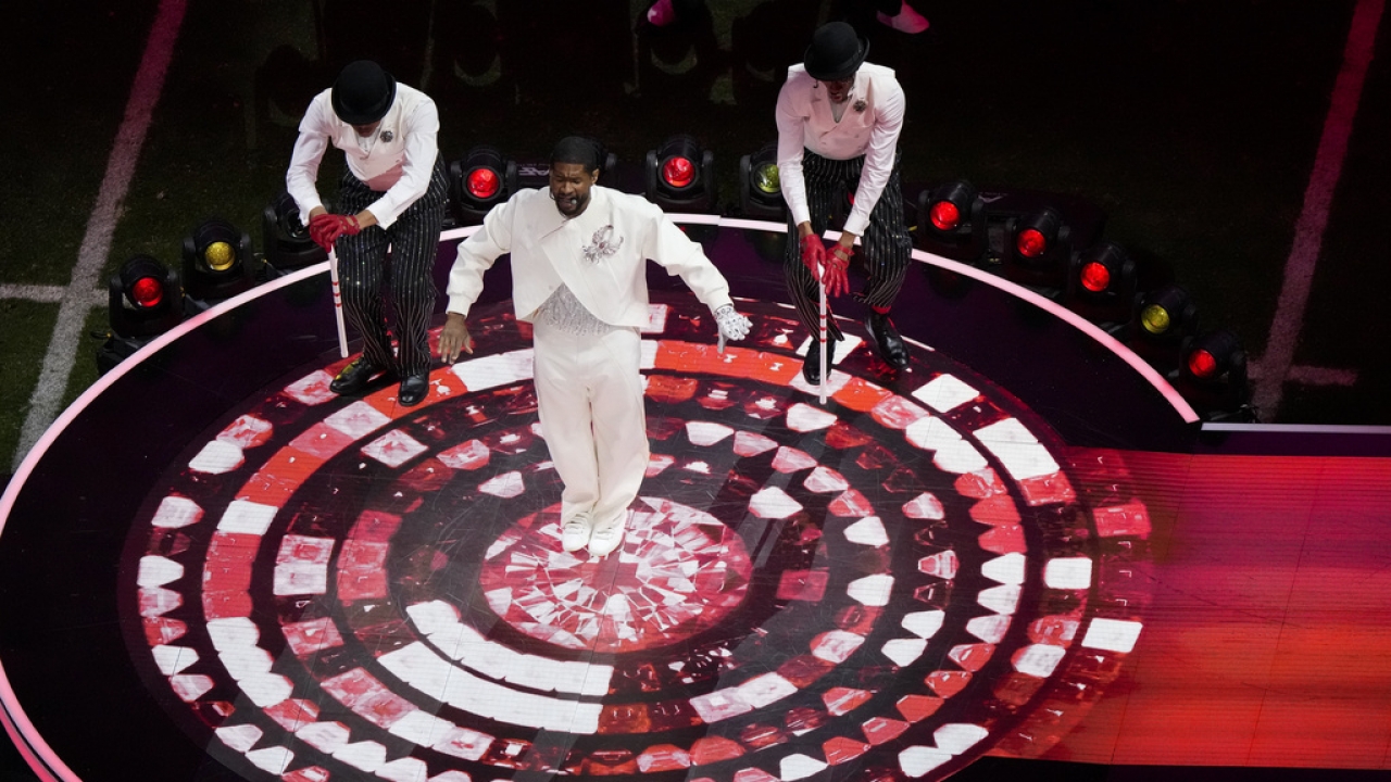 Usher, center, performs during halftime of the NFL Super Bowl 58.