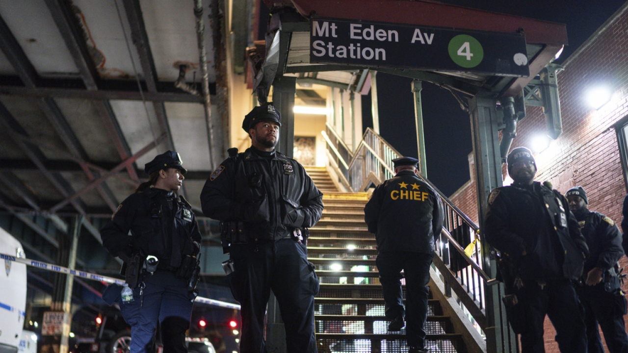 New York City Police officers stand guard following a shooting at the Mount Eden subway station.