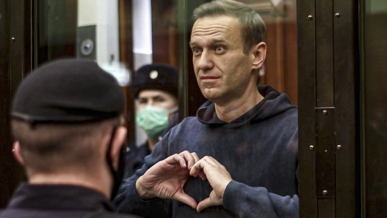 Russian opposition leader Alexei Navalny shows a heart symbol while in court